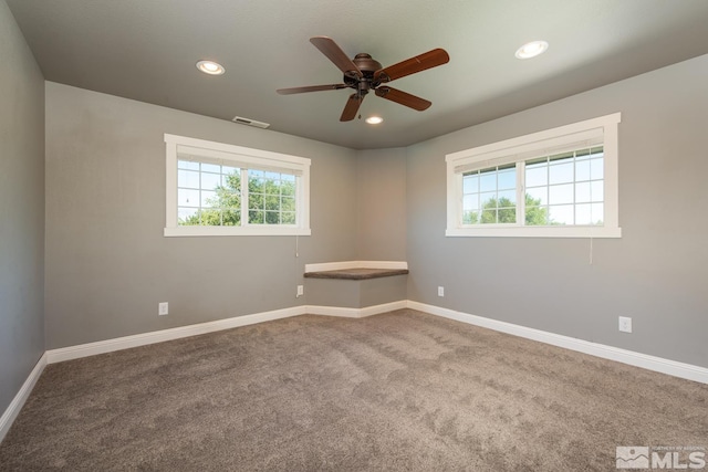 empty room featuring ceiling fan and carpet floors