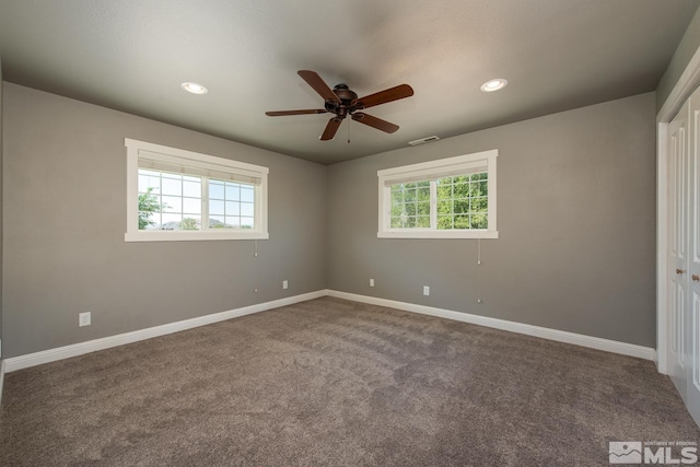 interior space with a closet, ceiling fan, and carpet