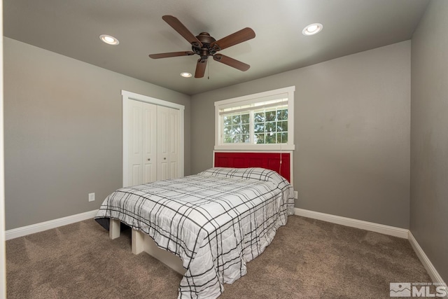 carpeted bedroom featuring ceiling fan and a closet