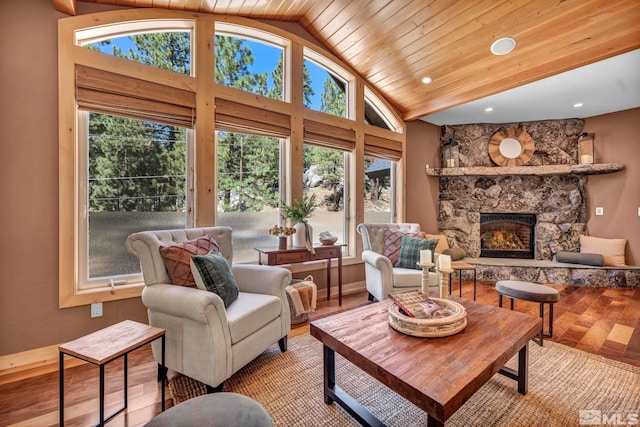 living room with lofted ceiling, hardwood / wood-style floors, and a fireplace