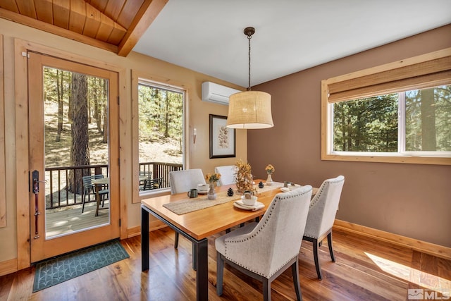 dining area with wooden ceiling, hardwood / wood-style floors, beamed ceiling, and a wall unit AC