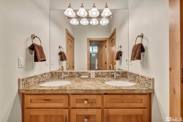 bathroom featuring tasteful backsplash and vanity