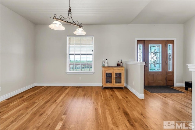 foyer entrance with light wood-type flooring