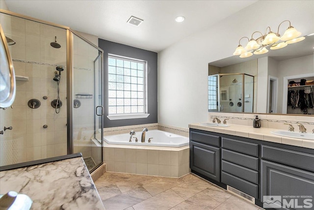 bathroom with shower with separate bathtub and vanity