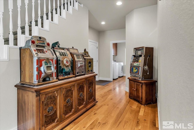 hall featuring washing machine and dryer and light hardwood / wood-style floors