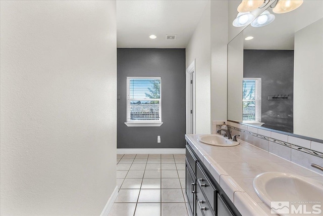 bathroom featuring tile patterned flooring, a wealth of natural light, and vanity