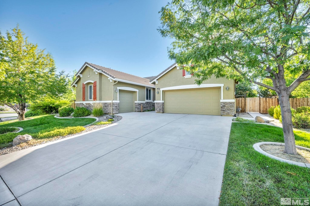 view of front of house featuring a garage and a front lawn