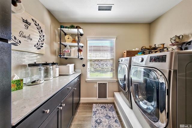 washroom featuring cabinets and separate washer and dryer