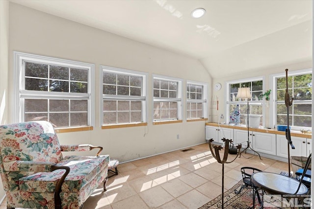 sunroom featuring lofted ceiling