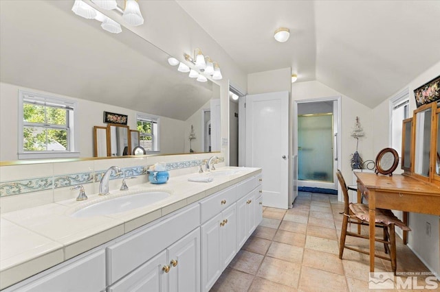 bathroom with vaulted ceiling and vanity