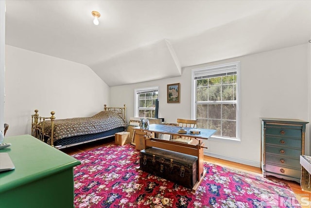 bedroom featuring vaulted ceiling and hardwood / wood-style flooring