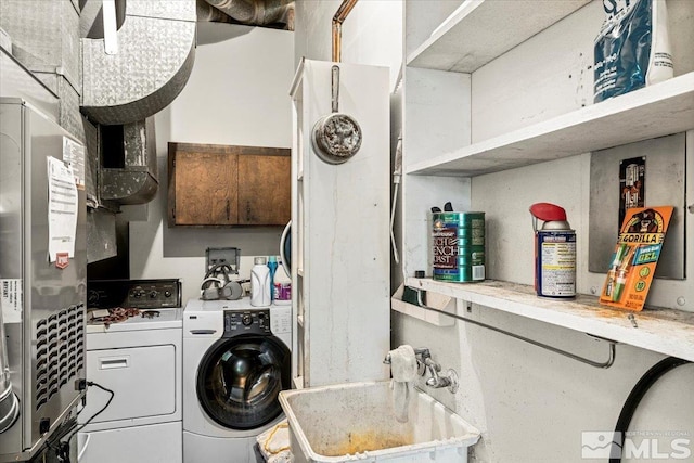 laundry room with washer and dryer and sink