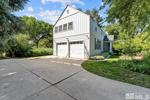 view of property exterior featuring a yard and a garage