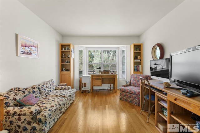 living room with plenty of natural light and light hardwood / wood-style flooring