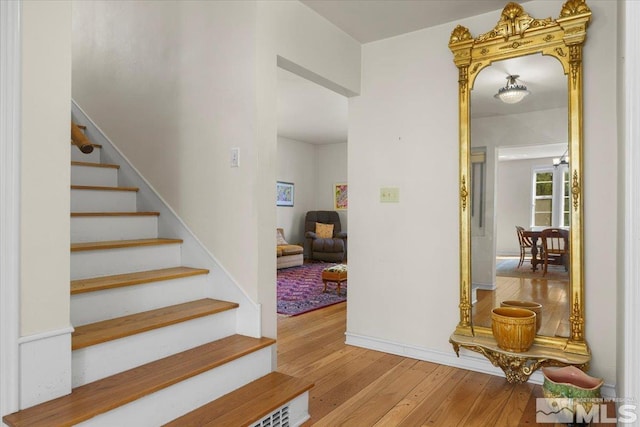 stairs with hardwood / wood-style flooring