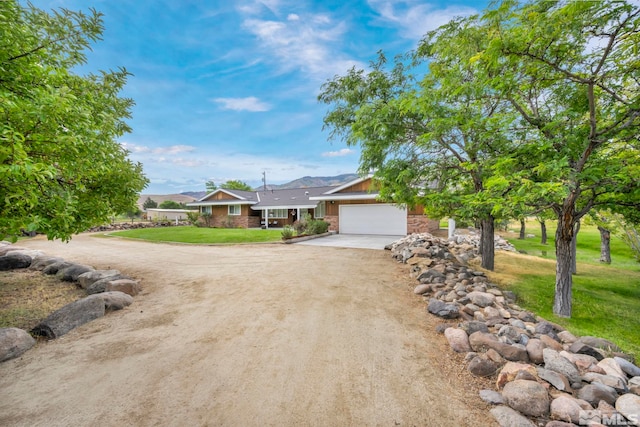 ranch-style home featuring a garage and a front lawn