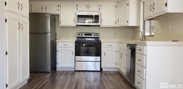 kitchen featuring white cabinetry, dark hardwood / wood-style flooring, and stainless steel appliances