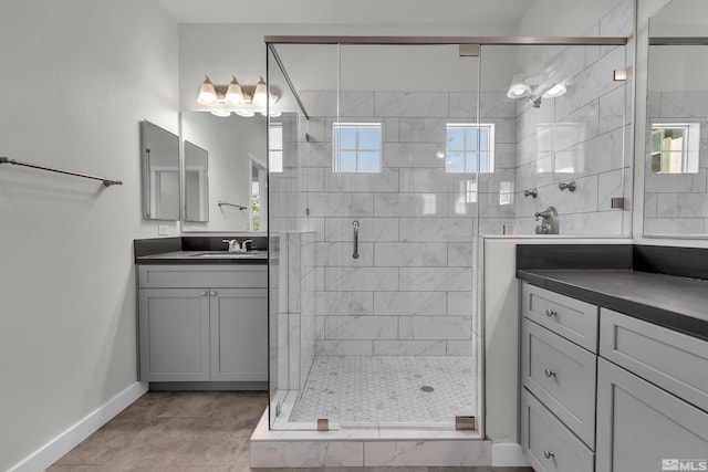 bathroom featuring a shower with door, vanity, and tile patterned floors