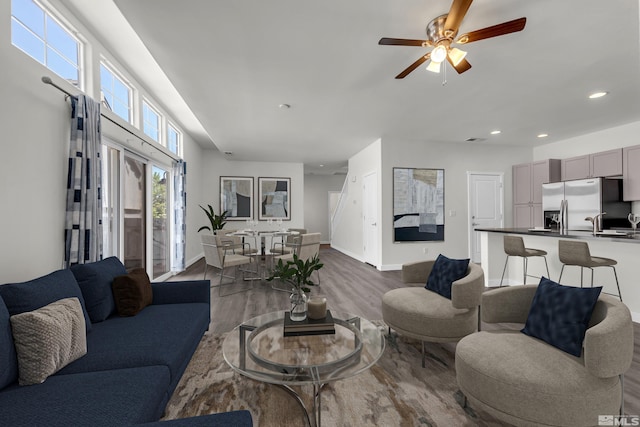 living room with a ceiling fan, baseboards, dark wood-style flooring, and recessed lighting