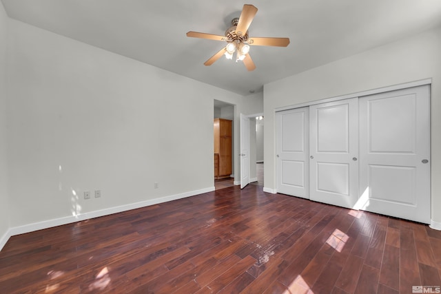 unfurnished bedroom featuring a closet, ceiling fan, and dark hardwood / wood-style flooring