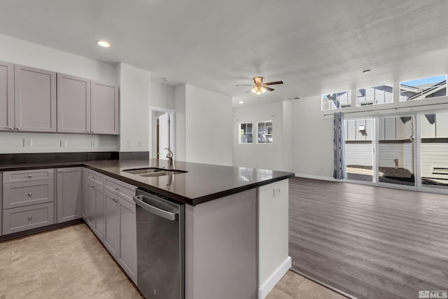 kitchen featuring dishwasher, gray cabinetry, kitchen peninsula, ceiling fan, and sink