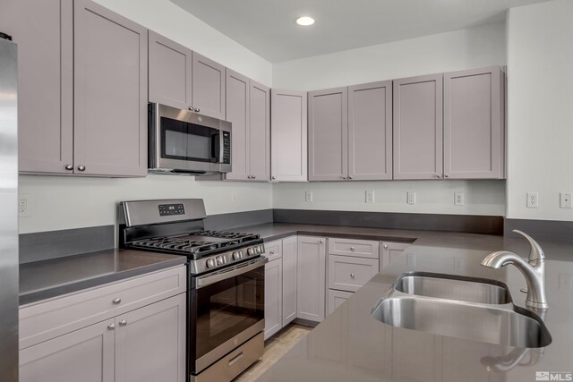 kitchen with sink, ceiling fan, stainless steel dishwasher, and light tile patterned floors