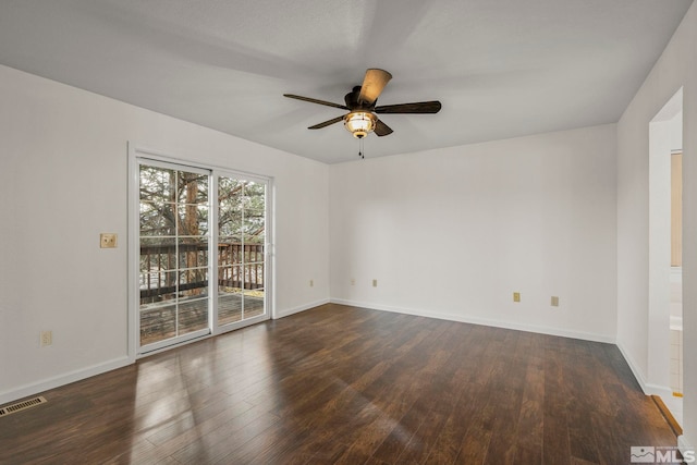 unfurnished room featuring ceiling fan, dark wood-type flooring, visible vents, and baseboards