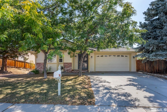 ranch-style house featuring driveway, brick siding, an attached garage, and fence