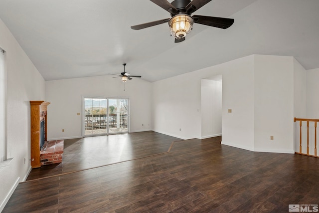 unfurnished living room with dark wood-style flooring, a fireplace, lofted ceiling, a ceiling fan, and baseboards