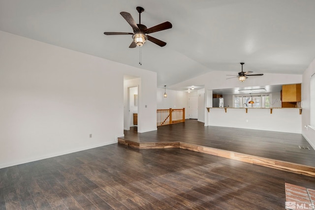 unfurnished living room featuring lofted ceiling, wood finished floors, and a ceiling fan