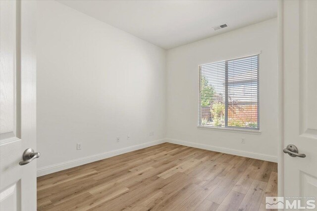 spare room with light hardwood / wood-style flooring