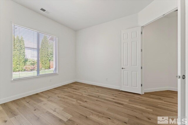 spare room with light wood-type flooring