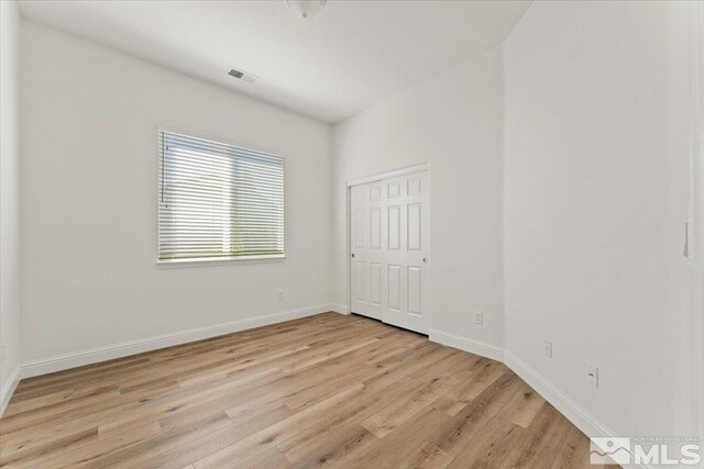 unfurnished room with light wood-type flooring