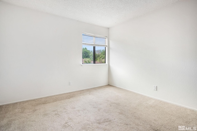 carpeted spare room with a textured ceiling