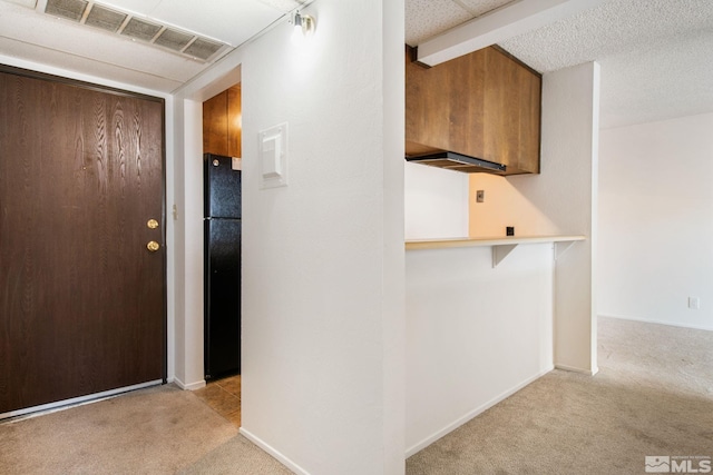 corridor with light colored carpet and beam ceiling