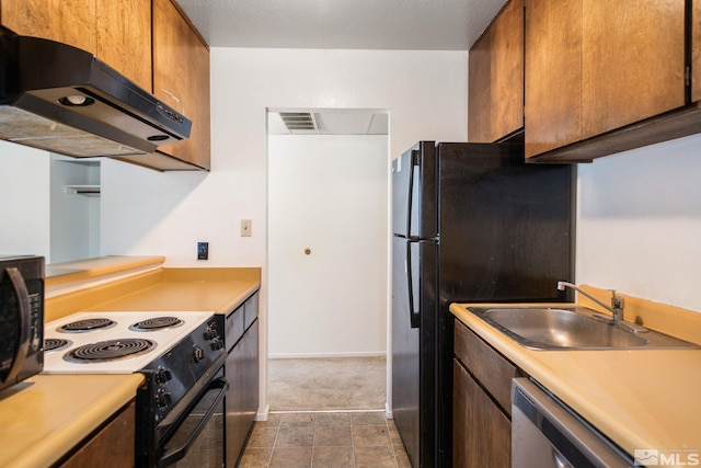 kitchen featuring black appliances, sink, and tile patterned floors