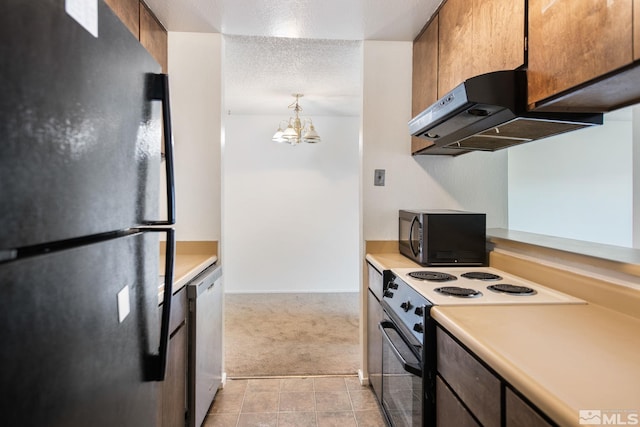 kitchen featuring ventilation hood, light colored carpet, a notable chandelier, black appliances, and a textured ceiling