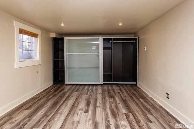 unfurnished bedroom featuring hardwood / wood-style flooring