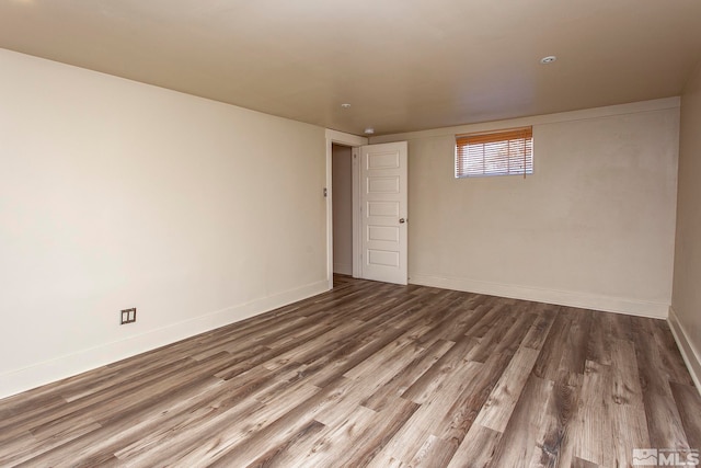 spare room with wood-type flooring