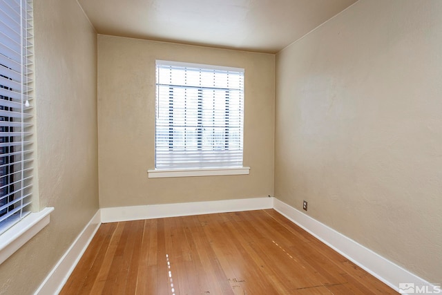 unfurnished room with wood-type flooring