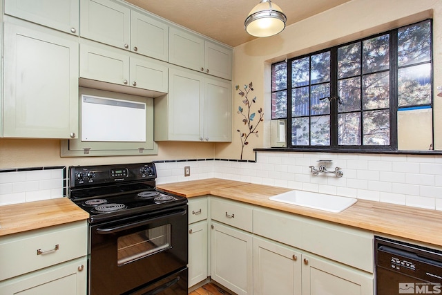 kitchen with black appliances, a healthy amount of sunlight, and wooden counters