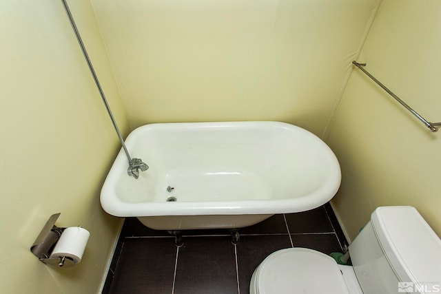 bathroom with toilet and tile patterned floors