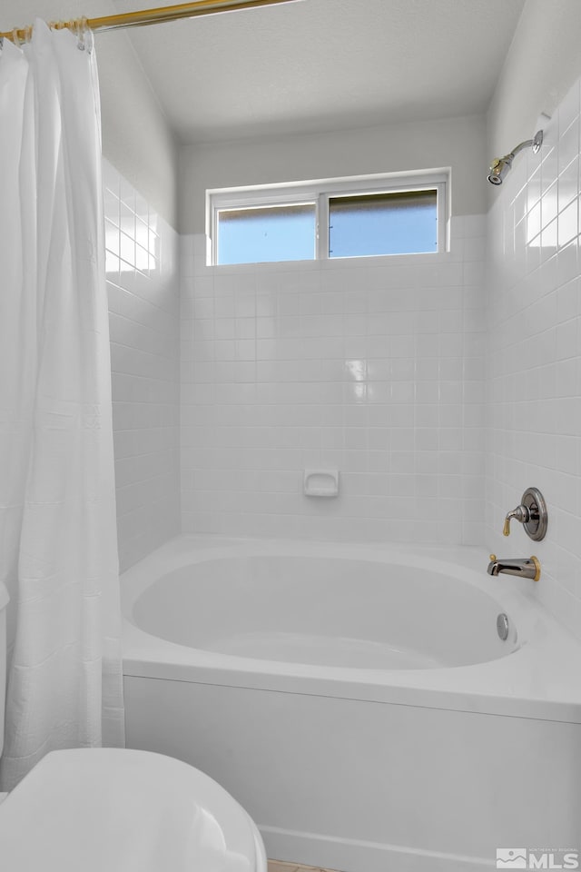 full bathroom with shower / bath combo and toilet