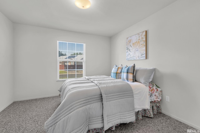 carpeted bedroom featuring baseboards