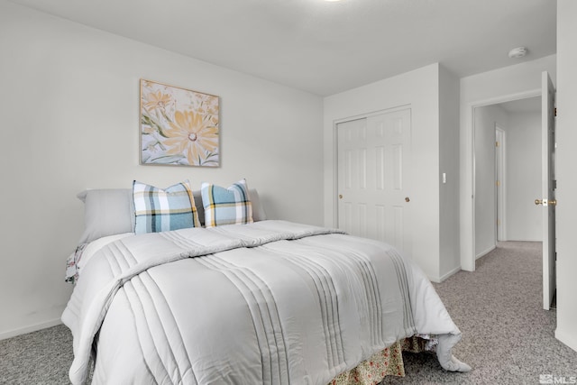 bedroom featuring carpet floors, a closet, and baseboards