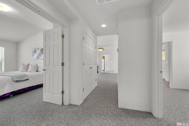 hallway with carpet and baseboards