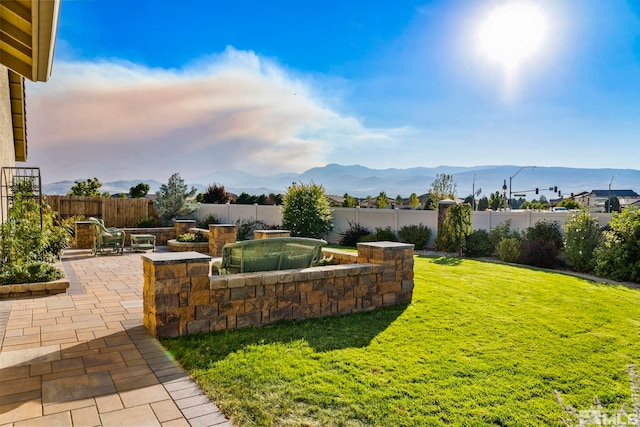 view of yard with a mountain view and a patio