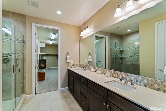 bathroom featuring tile patterned flooring, vanity, and an enclosed shower