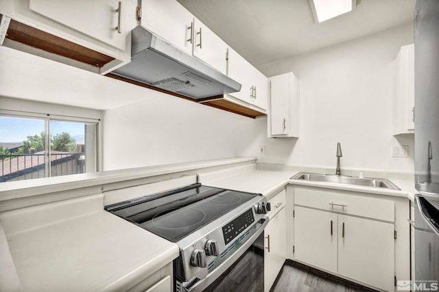 kitchen featuring dark wood-type flooring, sink, appliances with stainless steel finishes, and white cabinetry