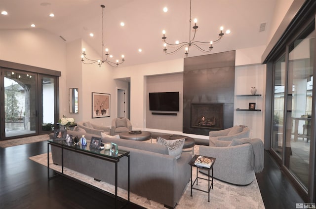 living room with a chandelier, a fireplace, wood finished floors, and recessed lighting